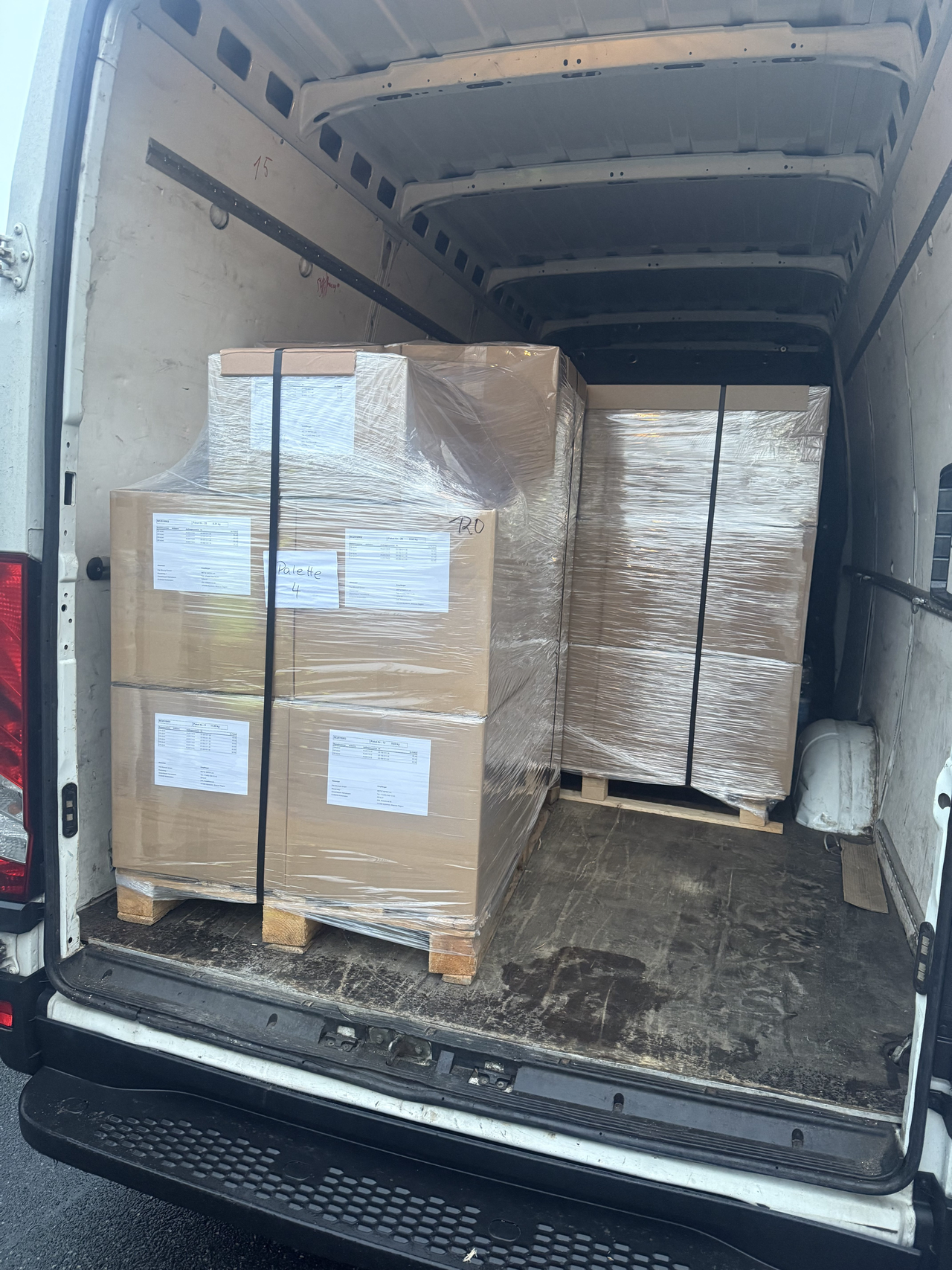 Palletised auto parts and showroom furniture prepared for transport